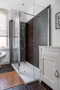 a glass shower in a bathroom with a sink at Amazing 5 Bed Victorian House - Clarence House in Birmingham