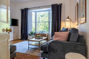 a living room with a couch and a window at Amazing 5 Bed Victorian House - Clarence House in Birmingham