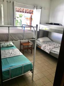 a room with two bunk beds and a window at Pousada Marazul in Maceió