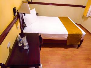 Postel nebo postele na pokoji v ubytování Hotel Madan Cárdenas