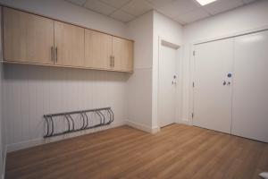 an empty room with a gym with wooden floors at Herongate Apartments in Hungerford