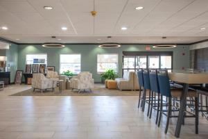 a waiting room with chairs and a table in a building at Holiday Inn & Suites Spring - The Woodlands in Spring