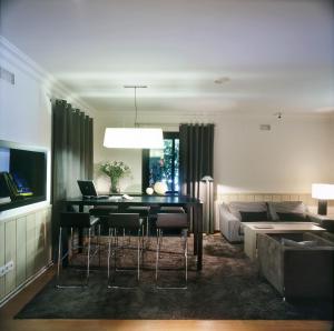 a living room with a table and a couch at CAN MARLET MONTSENY Hotel Boutique in Montseny +56 photos