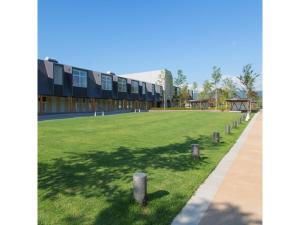a large grassy field in front of a building at OGAL INN - Vacation STAY 01857v in Akaishi