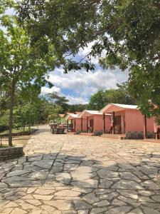 a group of buildings with a stone driveway at Pousada Cascata de Pedra in Pirenópolis