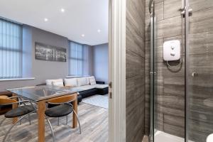 a room with a table and chairs and a couch at Darlington Town Centre Apartments free parking and Wi-Fi in Darlington +77 photos