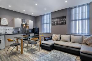 a living room with a couch and a table at Darlington Town Centre Apartments free parking and Wi-Fi in Darlington
