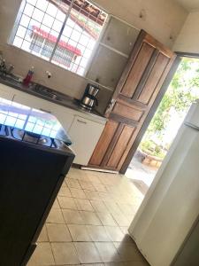 a kitchen with a stove and an open door at Pousada Marazul in Maceió