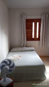 Giường trong phòng chung tại Hospedaria da Cris