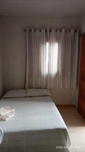 Giường trong phòng chung tại Hospedaria da Cris +1 ảnh