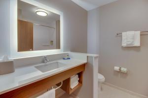 a bathroom with a sink and a toilet and a mirror at Holiday Inn Express & Suites - Union City, an IHG Hotel in Union City