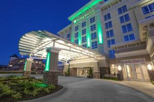 un hotel con un edificio iluminado por la noche en Holiday Inn and Suites East Peoria, an IHG Hotel en Peoria