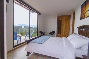 Postel nebo postele na pokoji v ubytování Hotel Casa Portones