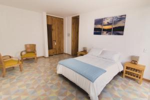Postel nebo postele na pokoji v ubytování Hotel Casa Portones