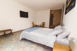 Postel nebo postele na pokoji v ubytování Hotel Casa Portones