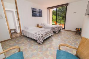Postel nebo postele na pokoji v ubytování Hotel Casa Portones
