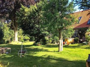un patio con un árbol y un columpio en 10 person holiday home in S nderborg, en Sønderborg