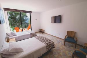 Säng eller sängar i ett rum på Hotel Casa Portones