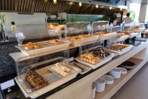 
a bakery display case filled with donuts and pastries at Holiday Ao Nang Beach Resort, Krabi - SHA Extra Plus Certified in Ao Nang Beach
