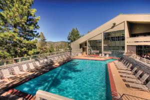 a swimming pool with chairs and a building at Holiday Inn Club Vacations - Tahoe Ridge Resort in Stateline