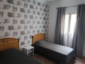 A bed or beds in a room at Alcaravaneras Hostel