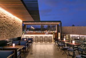 a restaurant with tables and chairs and a bar at InterContinental Sydney Double Bay by IHG in Sydney