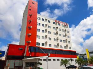 um hotel com um edifício vermelho e branco em Tri Hotel Smart Chapecó em Chapecó