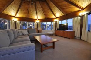 a living room with a couch and a tv at Marritz Hotel in Perisher Valley