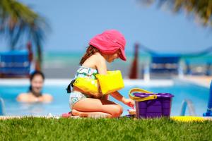 a little girl playing with a toy at a pool at Sollaris Ecopousada in Japaratinga