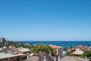 a view of a town with the ocean in the background at Dream View - Steps from the Beach & Secure Parking in Sydney