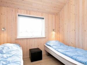 a room with two beds and a window at Luxury Retreat with Spa - By Traum Ferienwohnungen in Millinge