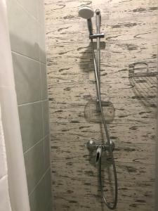 a shower head in a bathroom with water at Авиатик in Zhytomyr