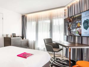 Телевизор и/или развлекательный центр в Novotel Deauville Plage