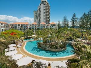 a resort with a large pool and a tall building at Calypso Plaza Resort Unit 141 in Gold Coast