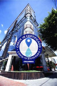 a building with a blue sign on the front of it at Hotel Boutique City Center in Bogotá