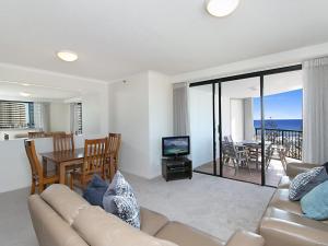 a living room with a couch and a table with a television at Calypso Tower Unit 807 in Gold Coast