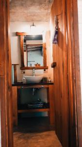 a bathroom with a sink and a mirror at Cabañas Bahia Serena in Punta Del Diablo