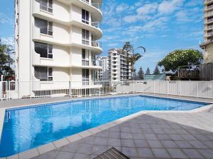 a swimming pool in front of a building at Classique Unit 3 in Gold Coast