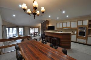 a large kitchen with a table and a dining room at Salzburg Apartments in Perisher Valley
