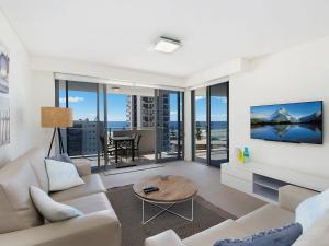 - un salon avec un canapé et une télévision dans l'établissement Eden Apartments Unit 901, à Gold Coast
