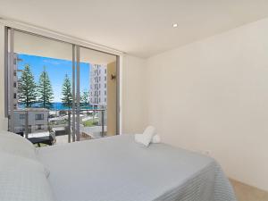a bedroom with a white bed and a large window at Maili 6 Luxury sky home in Gold Coast +16 photos