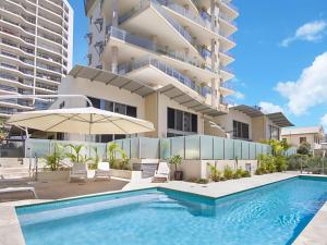 a swimming pool in front of a large building at Maili 6 Luxury sky home in Gold Coast