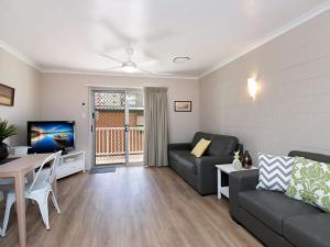 a living room with a couch and a table at Mavic Court Unit 4 in Gold Coast