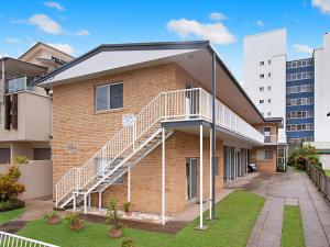 a brick building with a staircase on the side of it at Mavic Court Unit 4 in Gold Coast