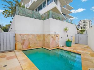 a swimming pool in front of a house at Nielsen on the Park Unit 1 3 Bed in Coolangatta