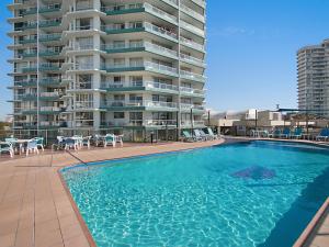 a large swimming pool next to a large apartment building at Ocean Plaza Unit 936 in Gold Coast