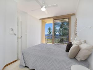 a bedroom with a bed and a large window at Orion Unit 7 in Gold Coast