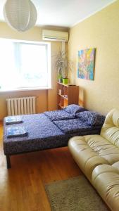 a bedroom with a bed and a couch in it at Alaska Fox in Kyiv