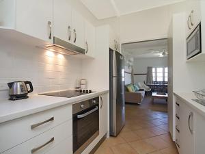 a kitchen with a sink and a refrigerator at Tondio Terrace Flat 1 in Gold Coast