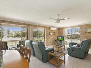 a living room with chairs and a table and a television at Tumut Unit 1 in Coolangatta